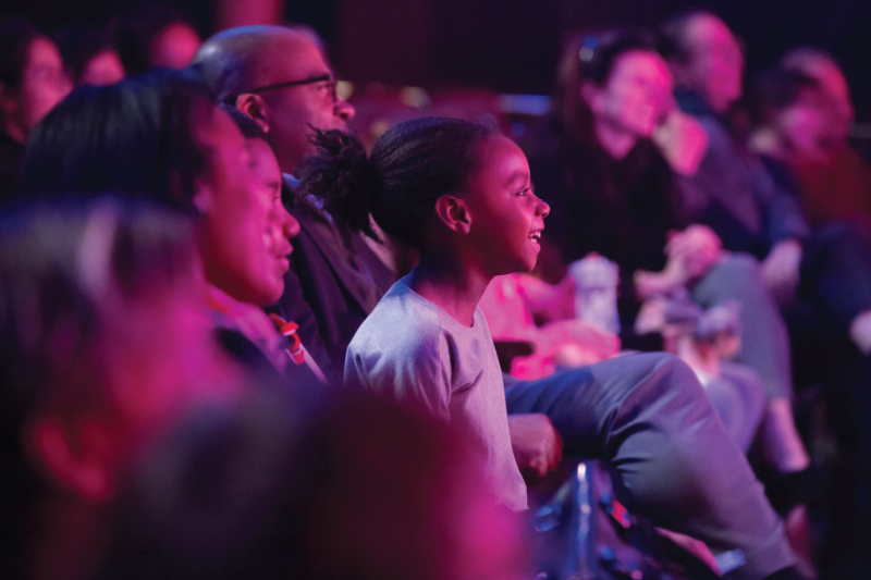 Young girl enjoying watching a performance