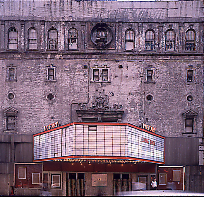 Dirty Victory Theatre facade with blank marquee and empty poster cases